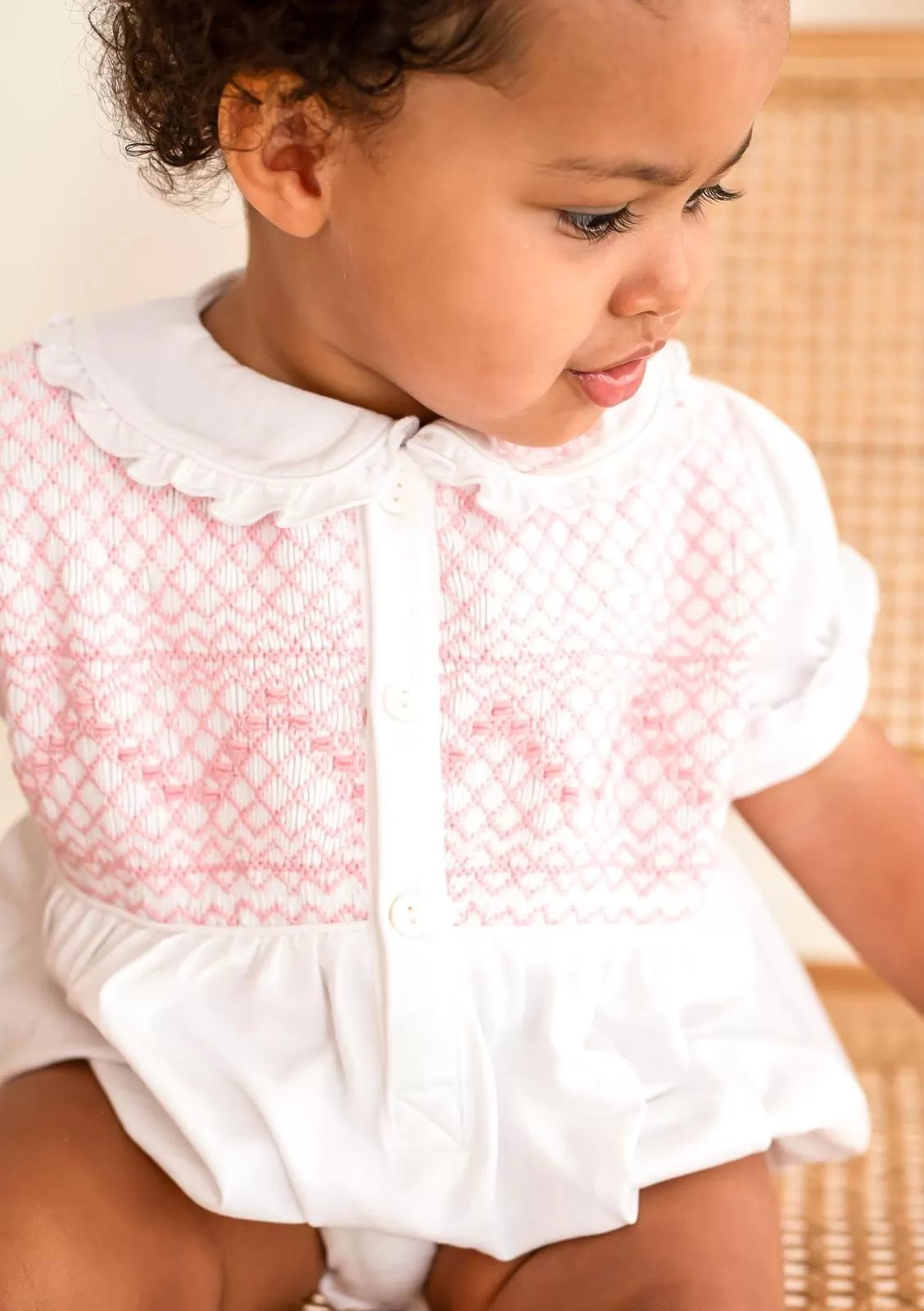 Girls White Smocked Romper Trimmed With Pink