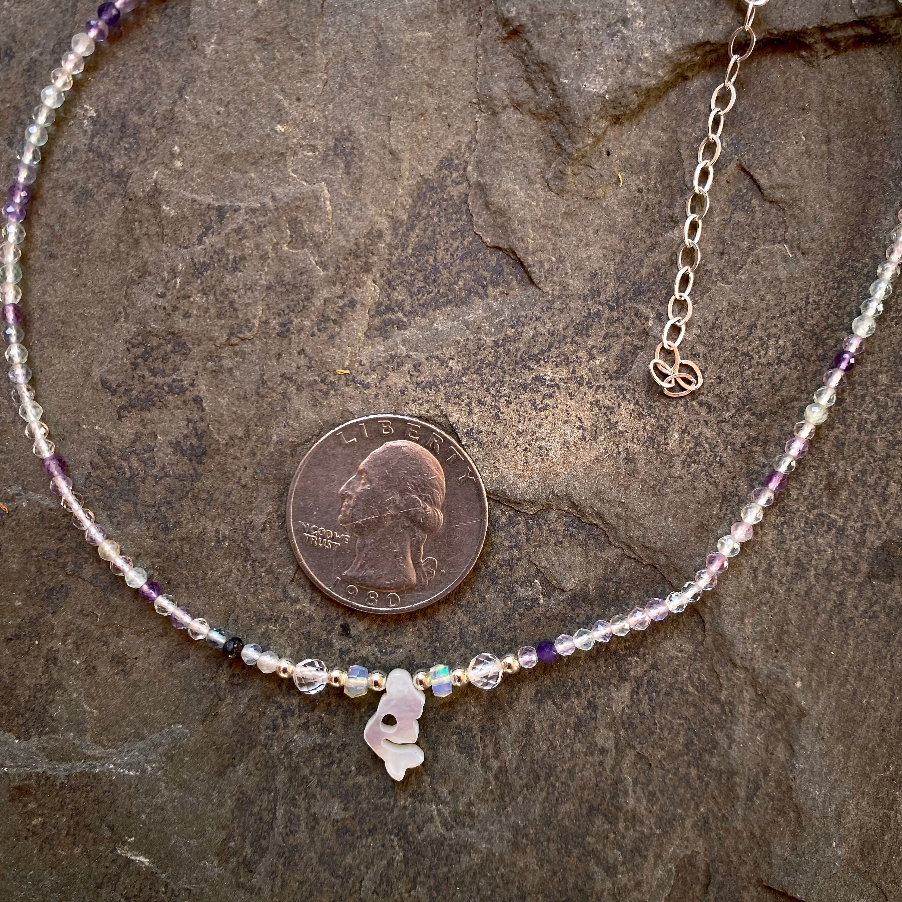 Mother of pearl mermaid on rainbow fluorite with Ethiopian opals, white topaz and sterling silver.