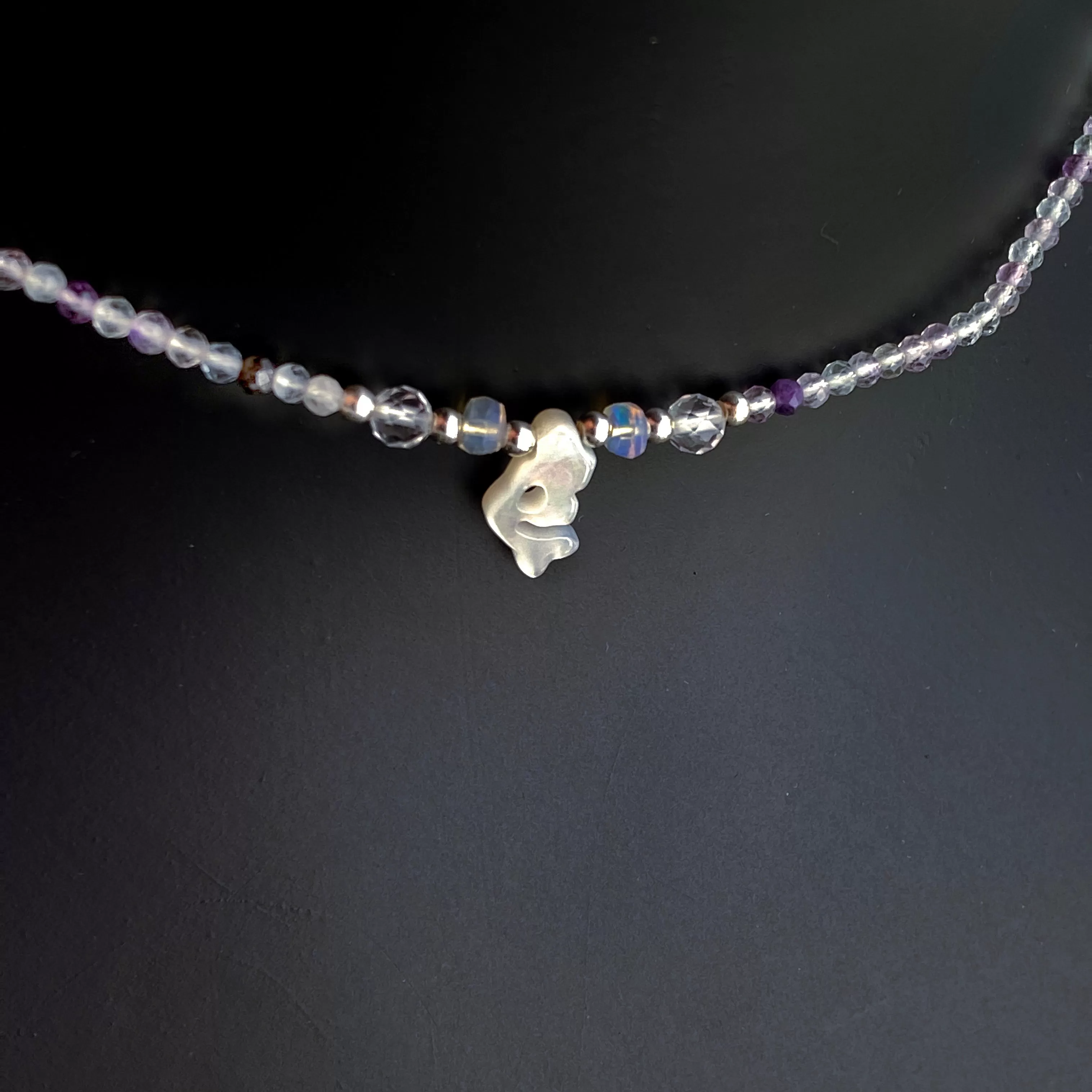 Mother of pearl mermaid on rainbow fluorite with Ethiopian opals, white topaz and sterling silver.