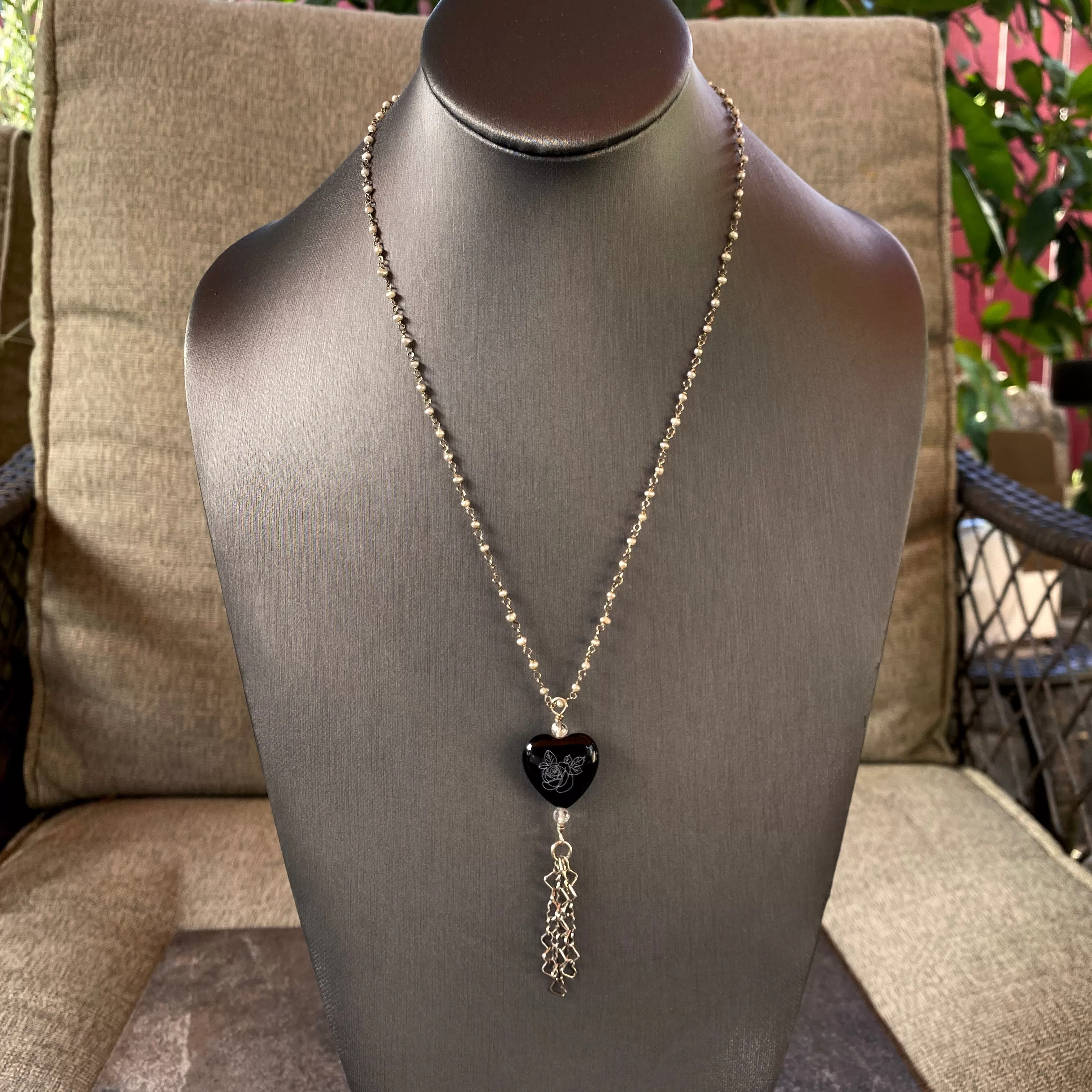 Sterling silver with freshwater pearls, painted onyx pendant, white topaz, hanging heart chain